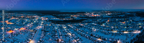 Aerial View Of Town Skyline Winter Night. Snowy Landscape Cityscape Skyline. panorama  panoramic Elevated View Night Starry Sky Above night town Landscape. Starry Sky.