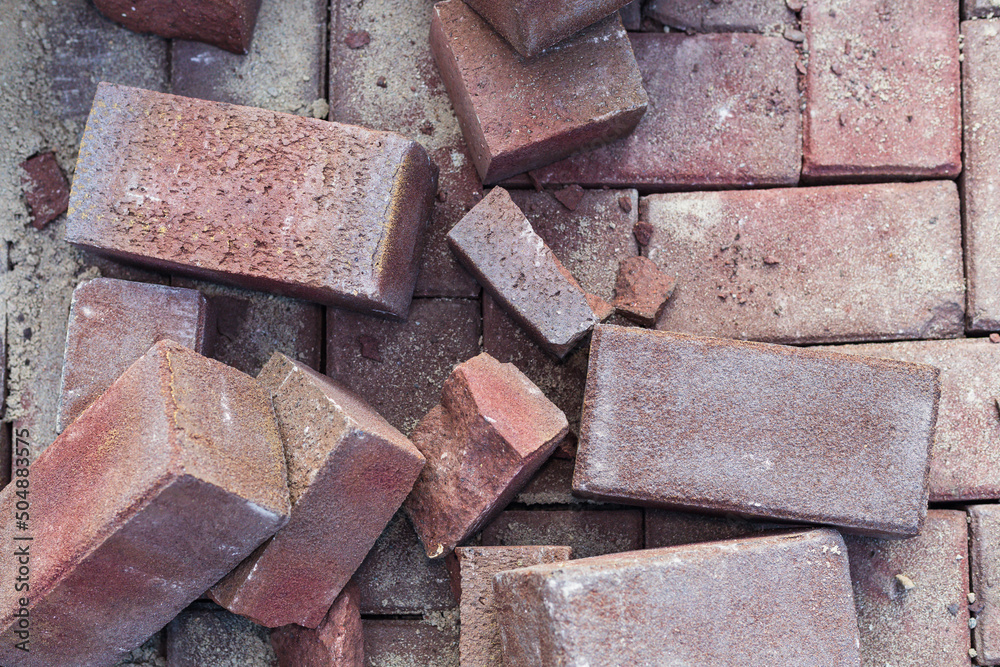 Pink bricks scattered on a newly renovated street. Rubble not yet cleared Pink bricks scattered on a newly renovated street. Rubble not yet cleared