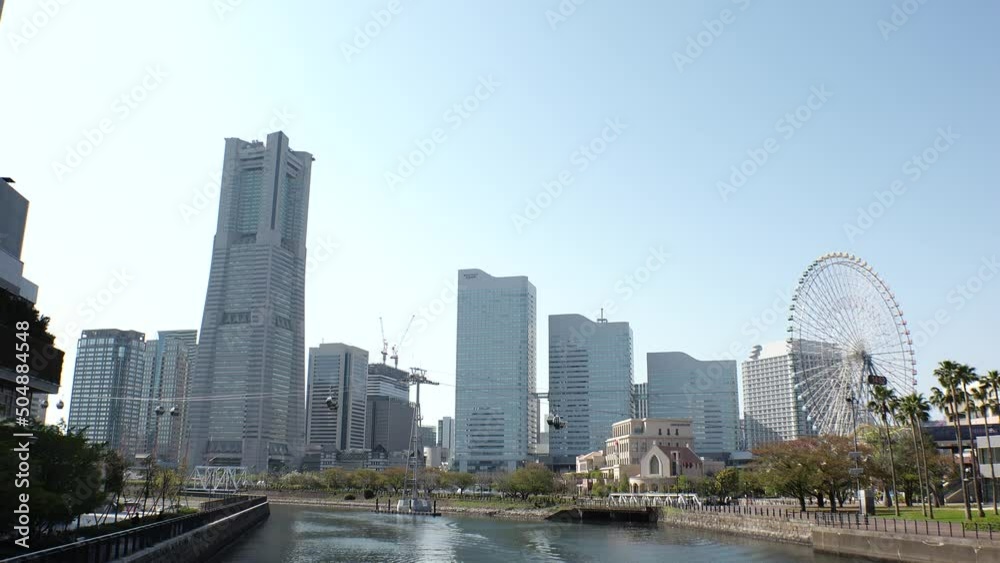 SAKURAGICHO, YOKOHAMA, JAPAN : Cityscape of Yokohama “Minatomirai” area. View of tall buildings at downtown area, near the harbor. Time lapse shot in sunny daytime. SAKURAGICHO, YOKOHAMA, JAPAN : Cityscape of Yokohama “Minatomirai” area. View of tall buildings at downtown area, near the harbor. Time lapse shot in sunny daytime.