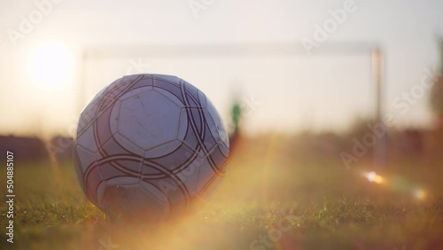 Close-up of a ball kicking at the goal. Playing football with a child in the stadium with a goal and a ball. photo