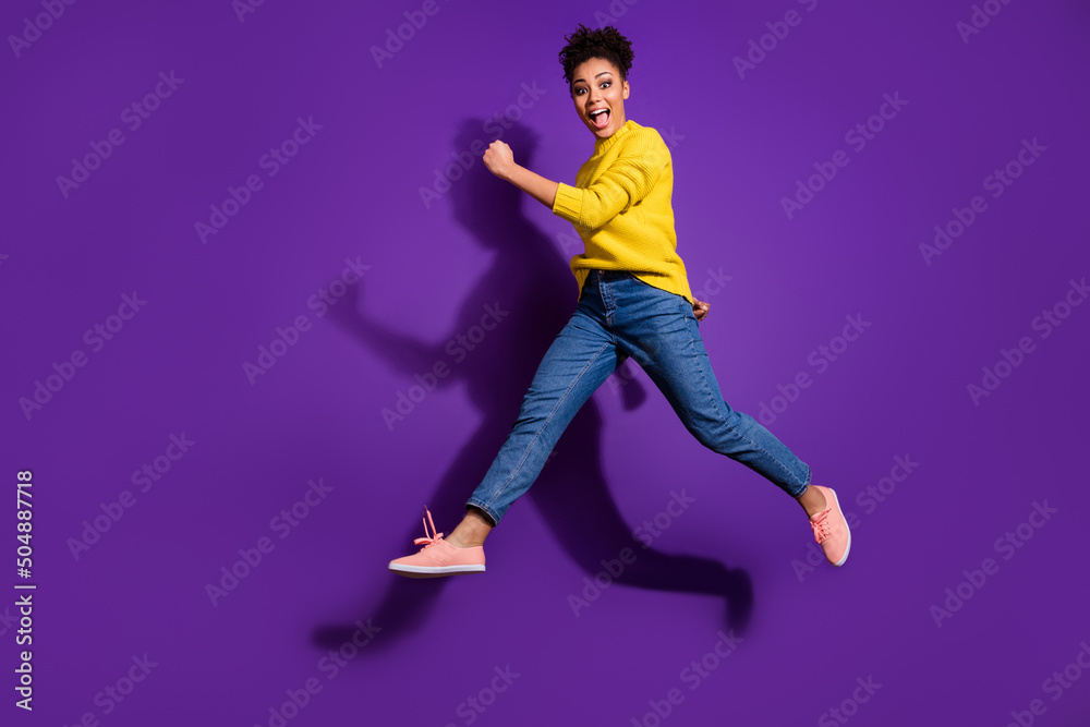 Full body portrait of energetic overjoyed girl jump rush fast isolated on purple color background