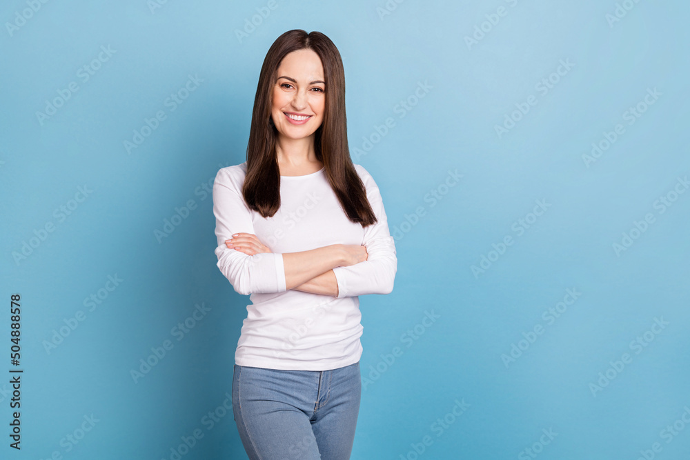 Photo of boss mature brunette lady crossed palms wear white shirt isolated on blue color background Photo of boss mature brunette lady crossed palms wear white shirt isolated on blue color background