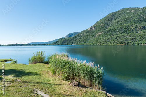 Italian bathing lake with clear waters. Panorama of Lake Mergozzo (lago di Mergozzo) towards lake Maggiore, valle Ossola. Province of Verbano Cusio Ossola in Piedmont region, Italy photo