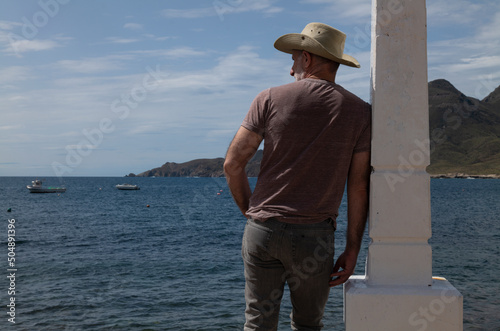 Rear view of adult man looking at view of sea