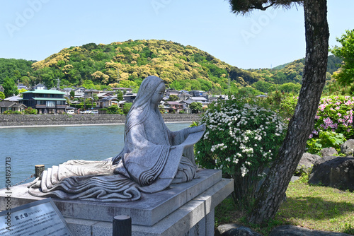 春の京都府宇治市の宇治川ほとりの紫式部像 photo