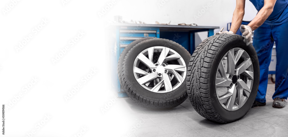 Concept banner service car wheel, changing winter tire with spikes on machine at station white background - obrazy, fototapety, plakaty 