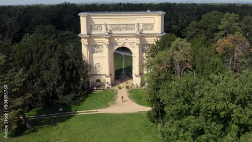 Woman runing under triumphal arch of Diana's temple in Moravia, drone. photo