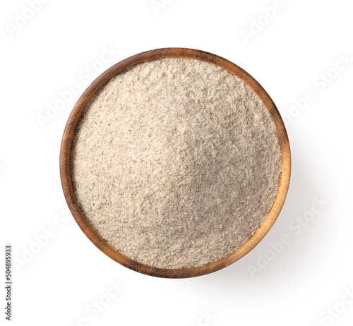 Tableau sur toile Raw rye flour in the wooden bowl, isolated on white background, top view