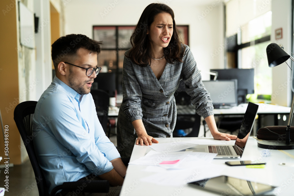 Colleagues arguing in office. Angry businesswoman yelling at her collegue. Colleagues arguing in office. Angry businesswoman yelling at her collegue.