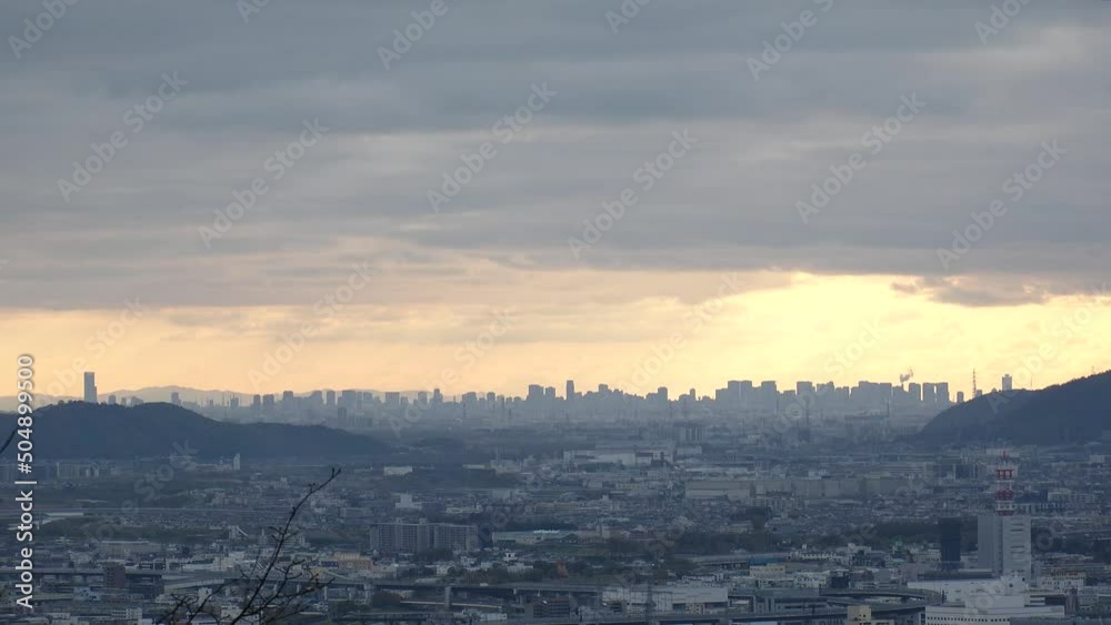 OSAKA, JAPAN - DECEMBER 2021 : Aerial panoramic view of downtown buildings at Osaka city in sunset time. View from Kyoto city in dusk. Japanese urban city concept video. OSAKA, JAPAN - DECEMBER 2021 : Aerial panoramic view of downtown buildings at Osaka city in sunset time. View from Kyoto city in dusk. Japanese urban city concept video.