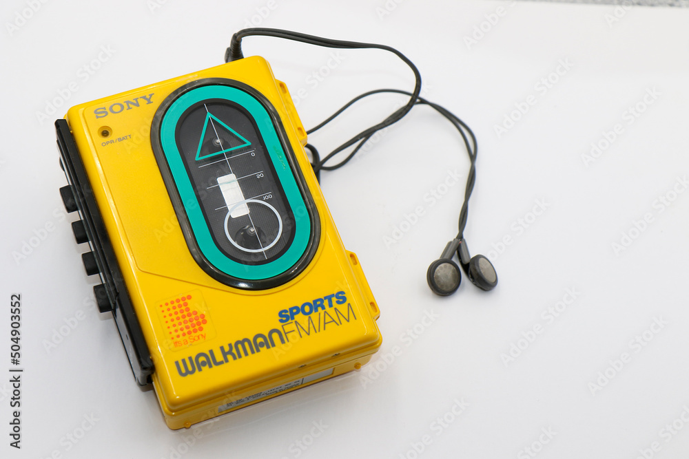 Foto de Sony Sports Walkman radio cassette player. Retro vintage portable audio music device 1980s. Earphones or in-ear headphones attached. Dublin, Ireland do Stock | Adobe Stock