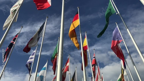 Flags of many countries vawing in the wind with blue sky and white clouds. for political, international trade, relationship concepts, international crisis, NATO organization, s photo