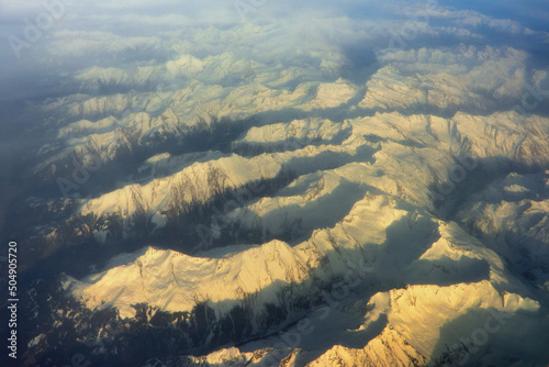 The aerial view of the Alps, with snow covered peaks photo