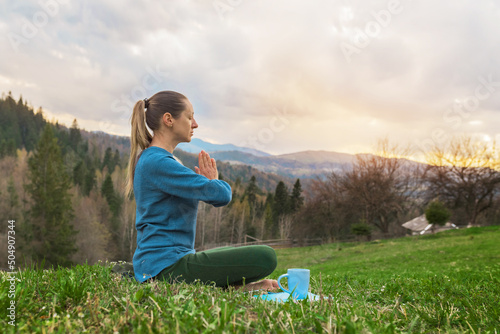 beautiful young women meditation yoga assana relaxing in nature in the mountains photo