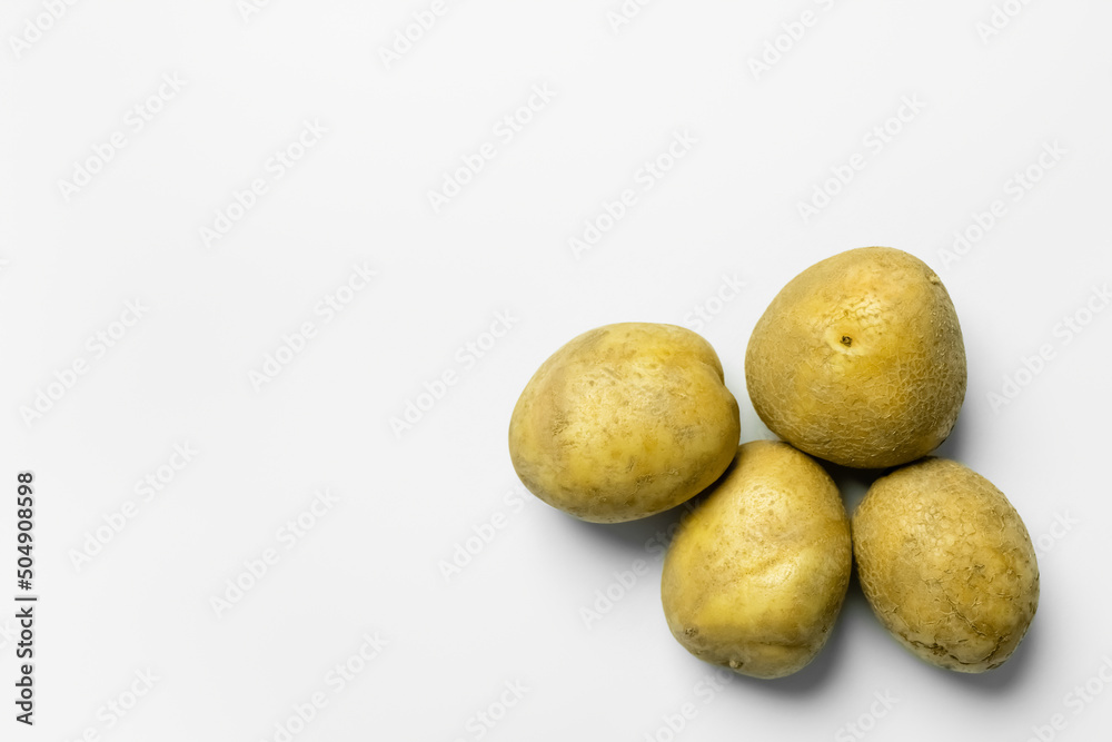Top view of ripe potatoes on white background. Top view of ripe potatoes on white background.