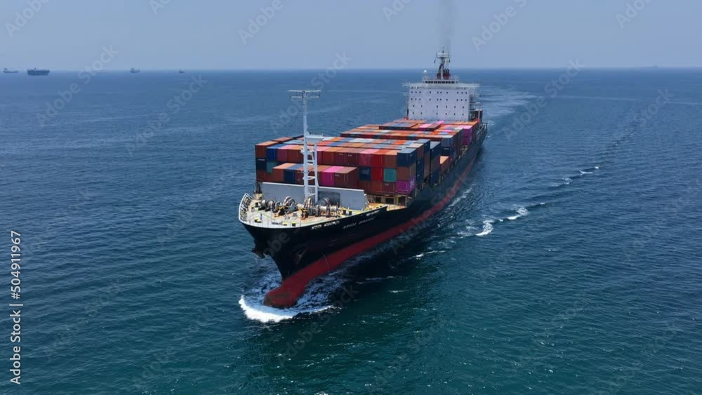 Aerial in front view of cargo ship carrying container and running with tug boat for export goods on clam sea from cargo yard port to custom ocean concept freight shipping by ship . Aerial in front view of cargo ship carrying container and running with tug boat for export goods on clam sea from cargo yard port to custom ocean concept freight shipping by ship .