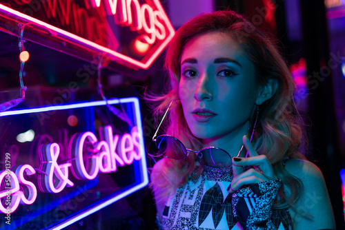 Cinematic night portrait of girl and neon lights 