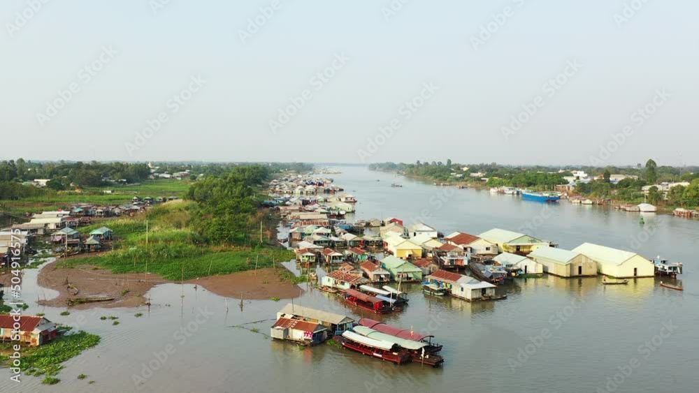 Boats moored in the middle of the Mekong River at Chau Doc in Asia, Vietnam, Mekong Delta, towards Ho Chi Minh city, in summer, on a sunny day. Boats moored in the middle of the Mekong River at Chau Doc in Asia, Vietnam, Mekong Delta, towards Ho Chi Minh city, in summer, on a sunny day.