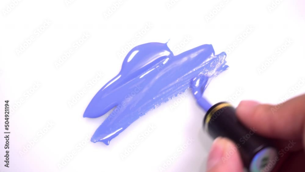 blue nail polish with nail brush Placed on a white background.