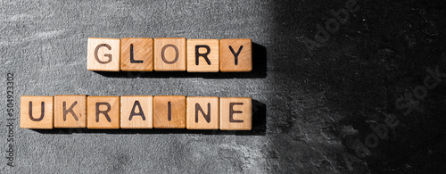 Glory Ukraine word is made of wooden blocks on the dark table