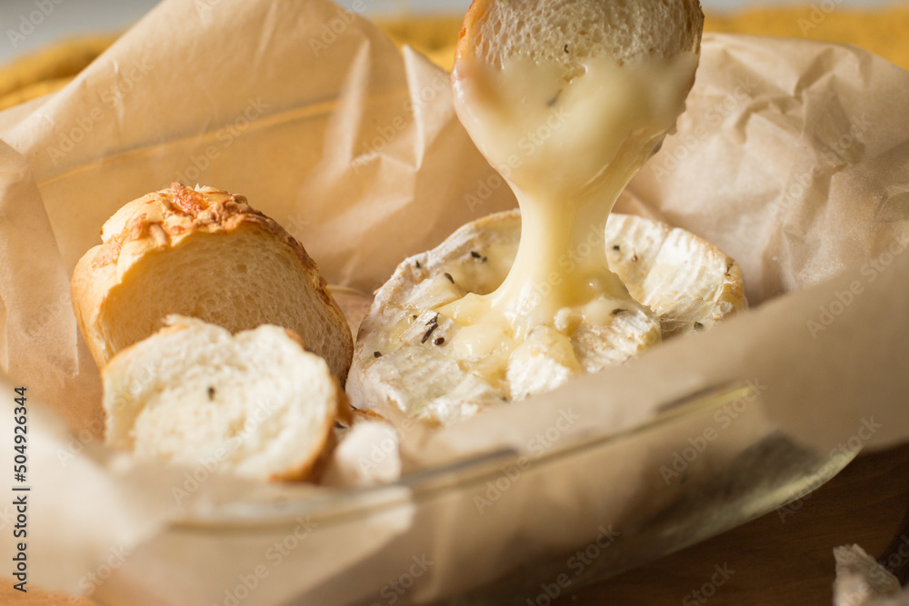Camembert cheese baked in the oven with garlic sauce and spices