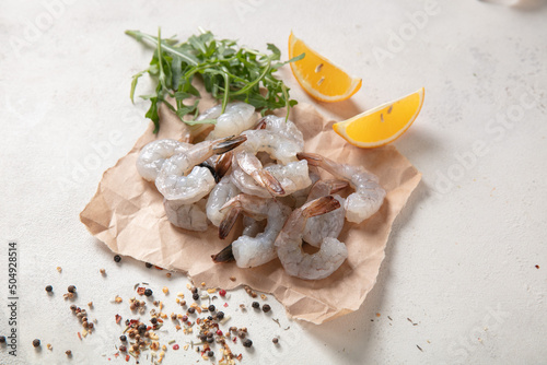 Fresh shrimp tails isolated. Raw headless prawn, pacific shrimp, uncooked tiger prawns, jumbo seafood on white background