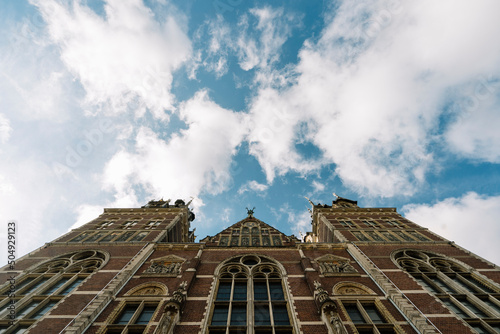 Facade of aged museum building with arched windows under blue sky photo