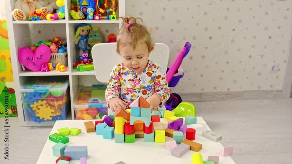 The child plays with toys in the room. Selective focus. The child plays with toys in the room. Selective focus.