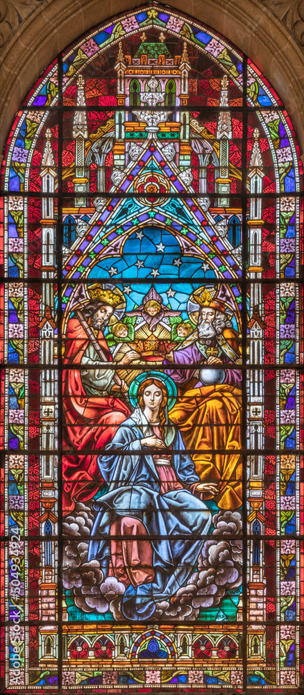 VALENCIA, SPAIN - FEBRUAR 17, 2022: The Coronation of Virgin Mary in neo-gothic stained glass of  church Basilica de San Vicente Ferrer by Talleres Maumejean Hermanos from 20. cent.
