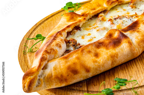 pide with meat and cheese on wooden plate isolated on white background photo