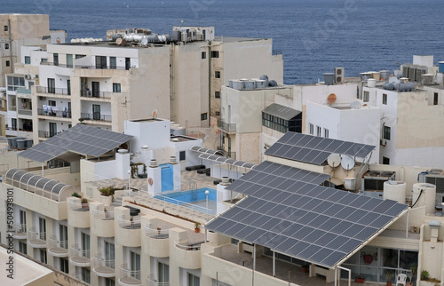 Solar panels on top floor. Alternative energy is used to heat water in sunny countries. Method of mounting and fixing solar panels as canopy over terrace. Eco-friendly alternative energy for house.