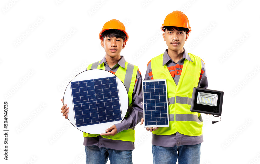 Two Asian young man wearing reflective vests and helmets are standing and holding solar panels and LED lights isolated on white background. Two Asian young man wearing reflective vests and helmets are standing and holding solar panels and LED lights isolated on white background.
