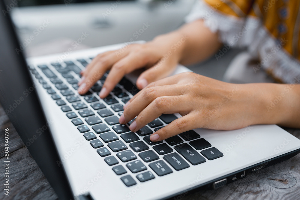 Female hands typing keyboard on laptop computer close up, businesswoman or student girl using laptop outdoor. Female hands typing keyboard on laptop computer close up, businesswoman or student girl using laptop outdoor.