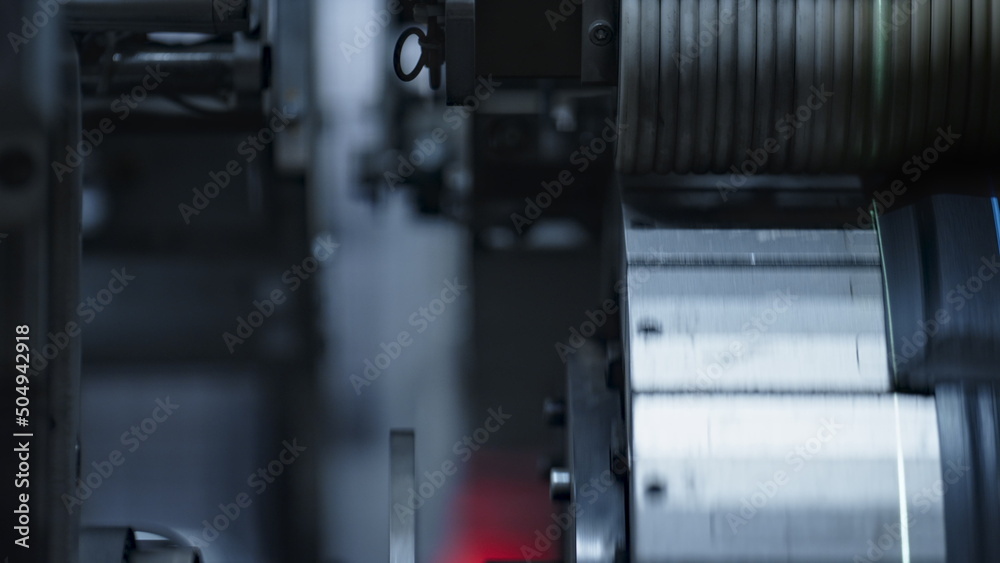 Detailed rubber tyre tape on mechanical automated machine rotating in plant Detailed rubber tyre tape on mechanical automated machine rotating in plant
