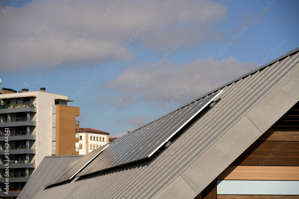 Fototapeta premium State-of-the-art solar panels placed on the roofs of houses of ecological construction