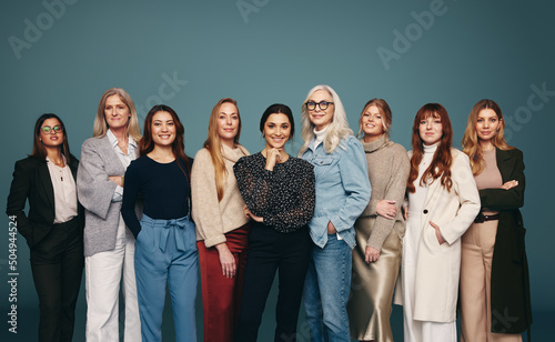 Cheerful group of women standing together in a row photo