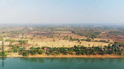 The arid countryside along the Mekong River at Stoeng Treng in Asia, Cambodia, towards Siem Reap, in summer, on a sunny day. photo