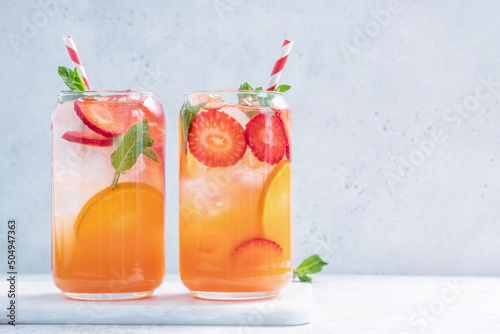 Orange cocktail with strawberries, summer drink