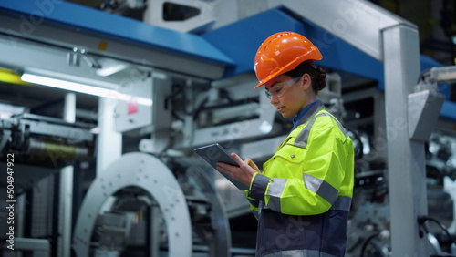 Engineer looking tablet computer in energy company. Modern factory concept. photo