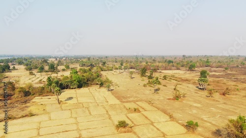 The arid and green countryside at Mekong level at Stoeng Treng in Asia, Cambodia, towards Siem Reap, in summer, on a sunny day. photo