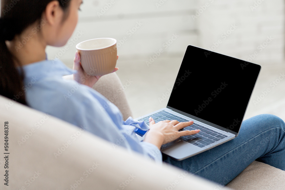 Over shoulder shot of asian woman using laptop, mockup Over shoulder shot of asian woman using laptop, mockup