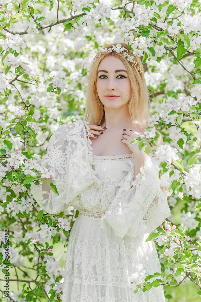 Bride at spring garden. Beautiful mix race lady in romantic lace dress with make up and flower wreath Bride at spring garden. Beautiful mix race lady in romantic lace dress with make up and flower wreath