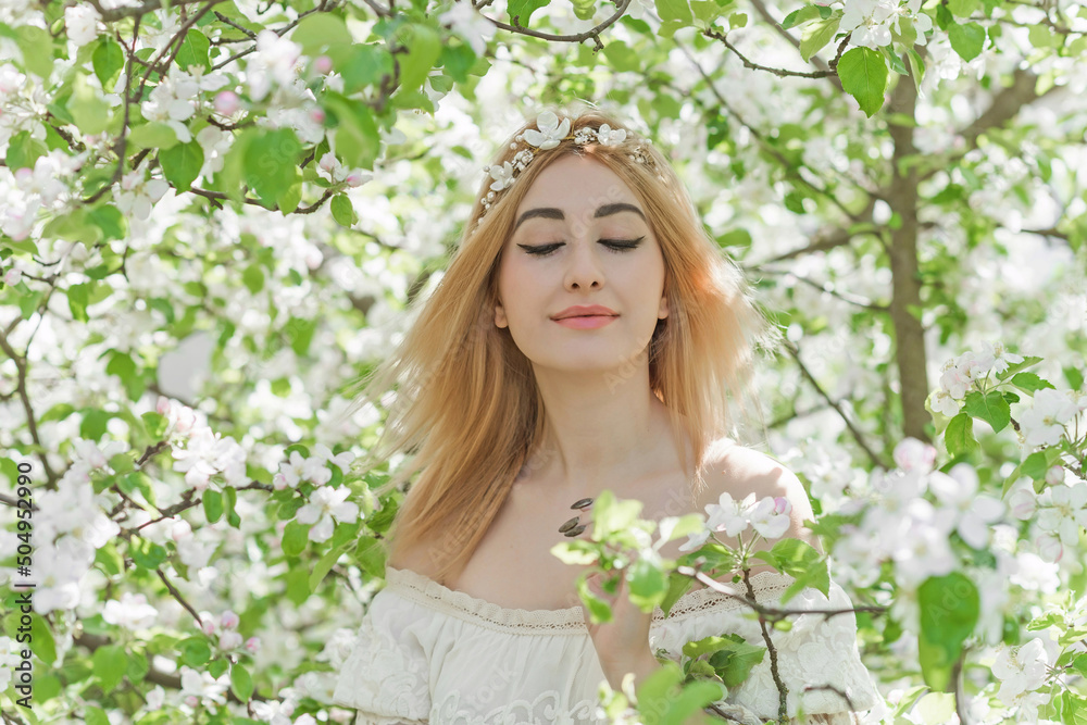 Bride at spring garden. Beautiful mix race lady in romantic lace dress with make up and flower wreath
