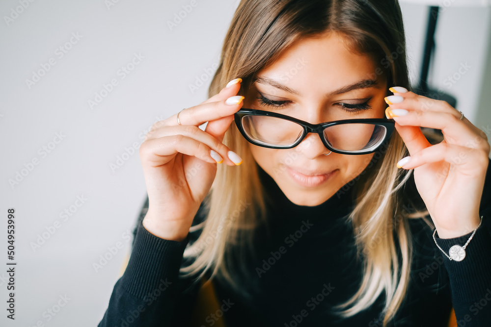 Young caucasian woman trying on glasses, close up. Young caucasian woman trying on glasses, close up.
