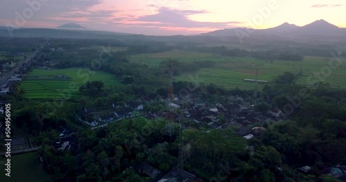 cellular antenna in the middle of the countryside with view of four mountains (telomoyo, andong, merbabu and merapi).