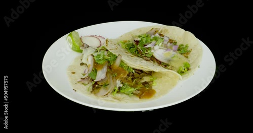 Two tacos with cheese on a turntable. Mexican food.  photo