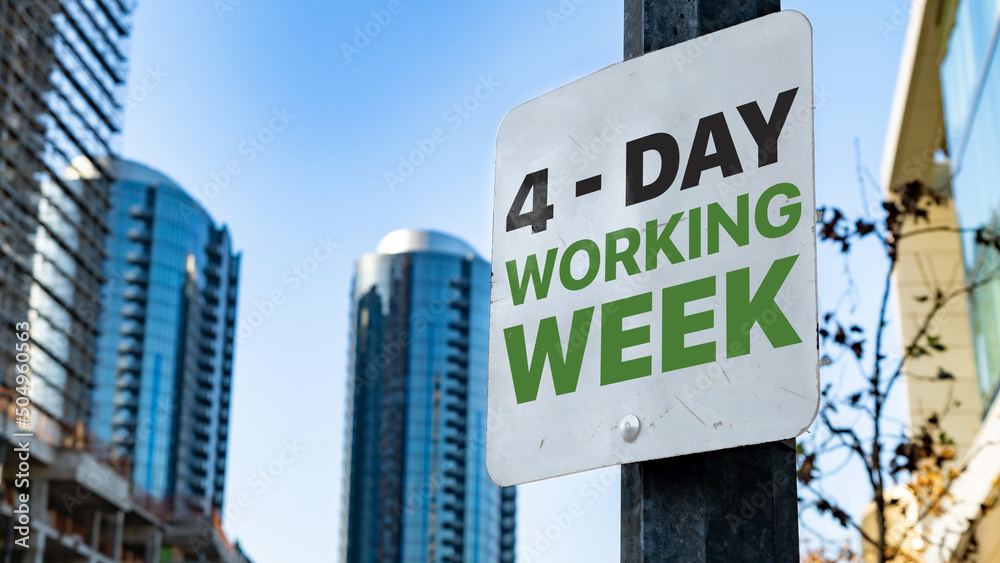 4 - Day Working Week on Worn Sign in Downtown city setting 4 - Day Working Week on Worn Sign in Downtown city setting