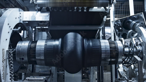 Obraz na plátne Robotic tire manufacturing machine stamping rubber tape in modern manufacture