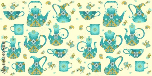 Richly decorated teapots, gravy boats, cups, mugs in yellow-green colors, as well as paisley and flowers on a light yellow background, form a beautiful seamless pattern.