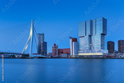 Rotterdam, Holland. View of the Erasmus Bridge and the city center. Long exposure photography. Cityscape in the evening. Skyscrapers and buildings.